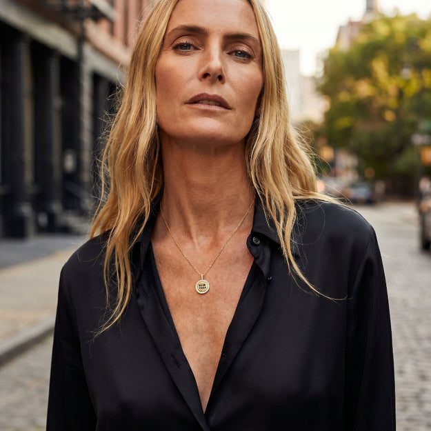 Woman wearing a black shirt with a blurred street background
