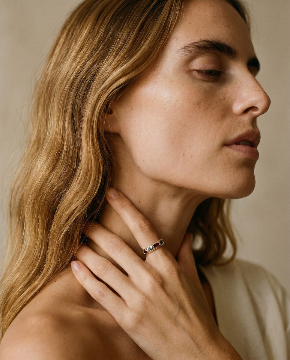 Personalized birthstone stacking rings worn together