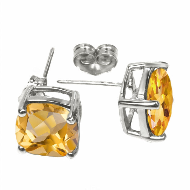 Silver earrings with orange gemstones on a white background