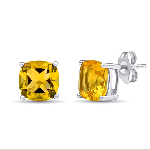 Yellow gemstone stud earrings with silver settings on a white background