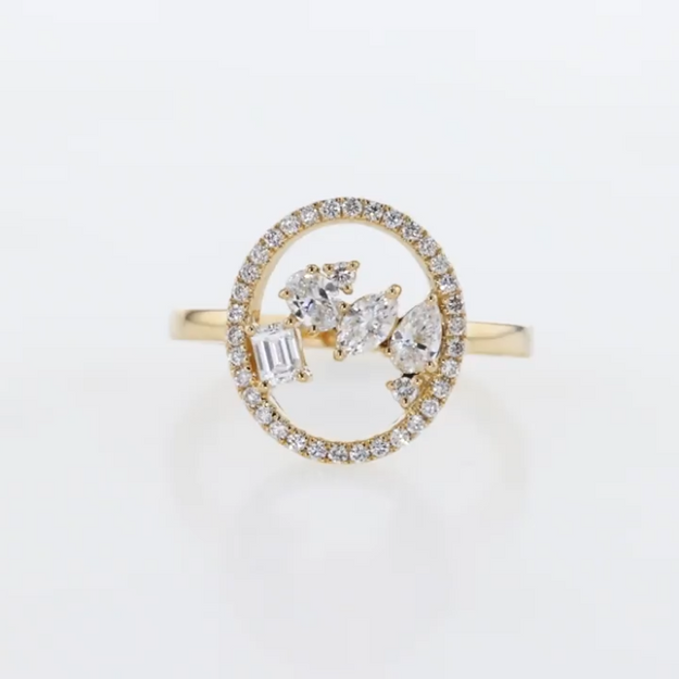 Gold ring with diamond accents on a light gray background
